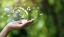 A hand holding symbols of sustainability